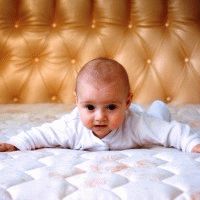Little baby on a big bed